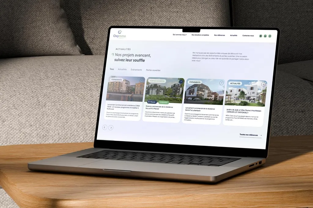 Écran d'ordinateur affichant la page Événements du site web Oxymmo, mettant en avant les actualités et les lancements de programmes immobiliers. Réalisation Prospectiv* Colmar